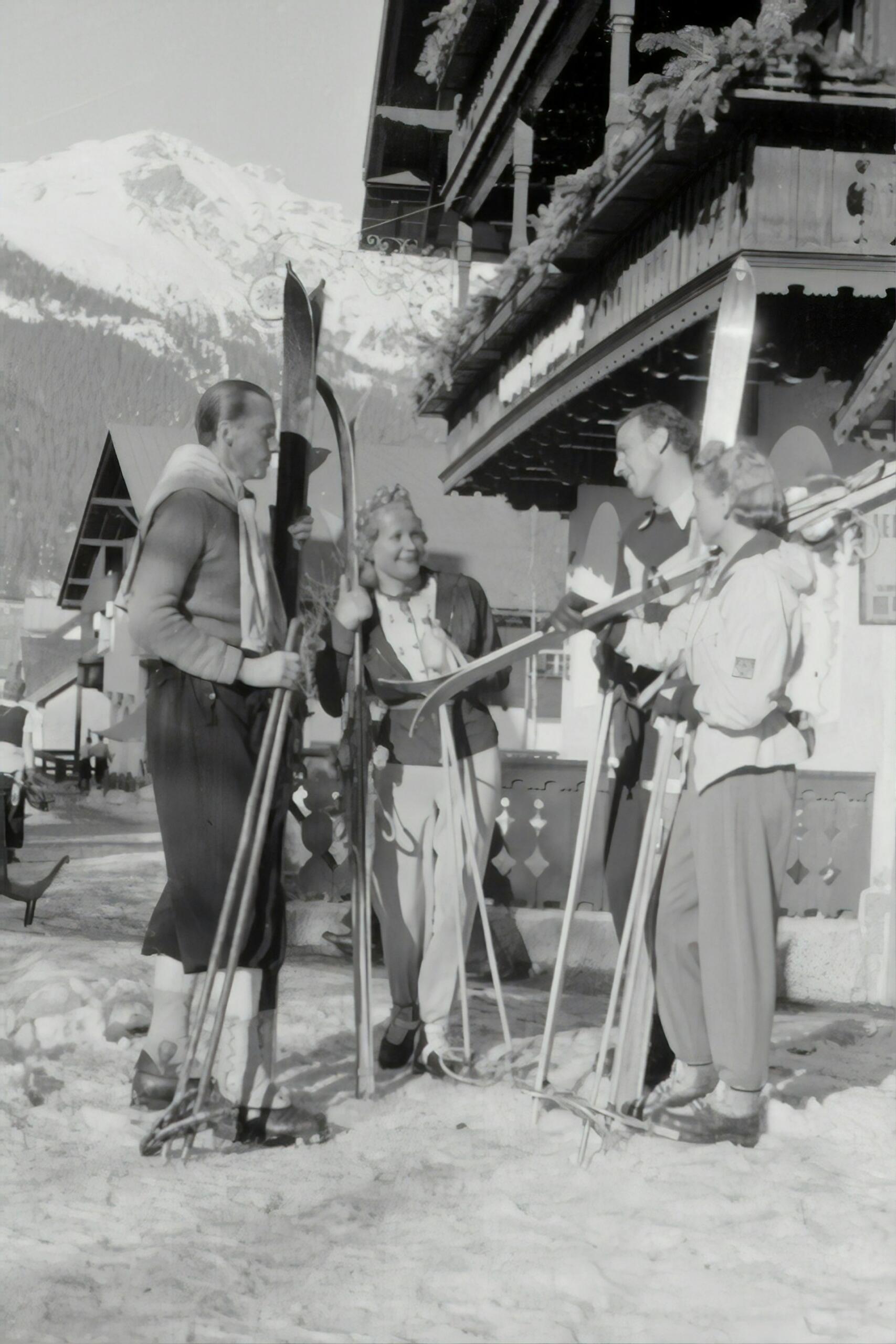 A photo depicting vacationers on the ski slopes in the last century.